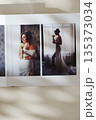 page of an open photo book with wedding photos on a white table 135373034