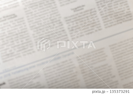 News articles showing recent events in a local newspaper on a table in the afternoon 135373291