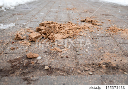 Sand and Debris Spread on Icy Winter Pedestrian Walkway Surface Sand and Debris Spread on Icy Winter Pedestrian Walkway Surface 135373488