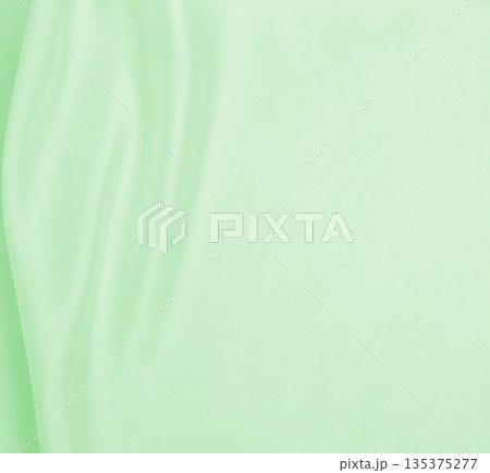 Smooth elegant green silk or satin luxury cloth texture as abstract background. Luxurious background design 135375277
