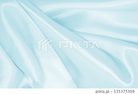 Smooth elegant blue silk or satin luxury cloth texture as abstract background. Luxurious background design 135375309
