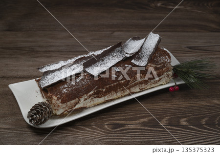 Tiramisu Tronchetto Dessert, Italian Yule Log Christmas dessert with chocolate bark 135375323