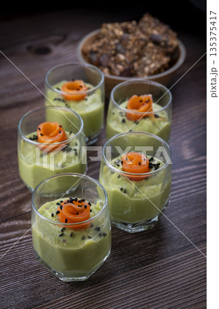Smoked salmon shot glasses guacamole served with homemade crackers Smoked salmon shot glasses guacamole served with homemade crackers 135375417