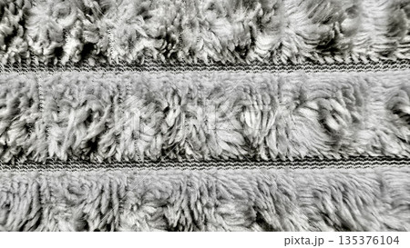 grayscale macro closeup of velcro fastener strips with fuzzy loops and hooked fibers in intricate textured detail for abstract tech wallpaper or industrial design banner grayscale macro closeup of velcro fastener strips with fuzzy loops and hooked fibers in intricate textured detail for abstract tech wallpaper or industrial design banner 135376104