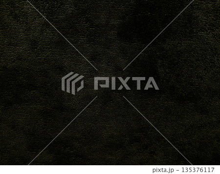 dark textured black fabric closeup with subtle green hues evoking mysterious eerie mood ideal for horror wallpaper or spooky banner background 135376117