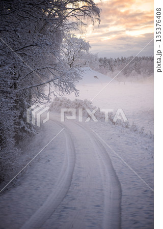 Snowy Farm Road With Distant Barn 135376408