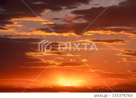 Natural Bright Gold Dramatic Sky In Sunset Dawn Sunrise. Amazing Bold Orange Sunset Sunrise Sky Background. Warm Yellow And Orange Colors Natural Bright Gold Dramatic Sky In Sunset Dawn Sunrise. Amazing Bold Orange Sunset Sunrise Sky Background. Warm Yellow And Orange Colors 135376768