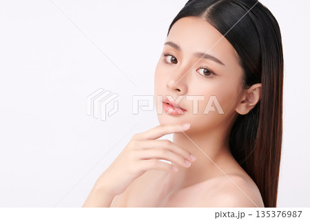 A beautiful young Asian woman with clean, fresh skin against a white background. Skincare, facial treatment, cosmetology, beauty, and spa. An elegant portrait of an Asian woman. A beautiful young Asian woman with clean, fresh skin against a white background. Skincare, facial treatment, cosmetology, beauty, and spa. An elegant portrait of an Asian woman. 135376987