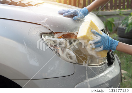 Washing a car with foam car wash solution. Washing a car with foam car wash solution. 135377129
