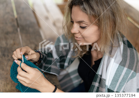 Knitting craft hobby woman creating winter blanket Knitting craft hobby woman creating winter blanket 135377194