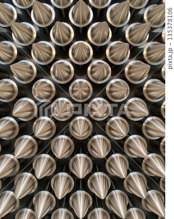 Array of sharp metallic cones.Abstract background image. An array of metallic cones arranged tightly in a radial pattern.  135378106