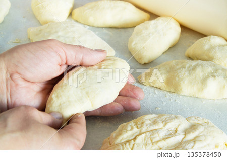 Female hands making biscuits and pie dough, close-up Female hands making biscuits and pie dough, close-up 135378450