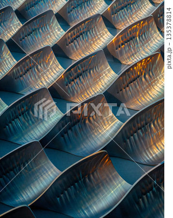 Shimmering metallic contours with dynamic light reflections. Abstract background image.Undulating metallic surfaces create dynamic light reflections, forming a repeating pattern. 135378814