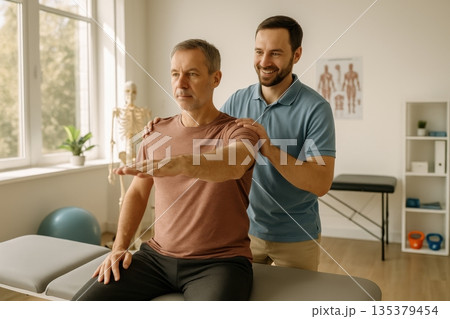 Physiotherapist helping patient with shoulder rehabilitation exercise 135379454