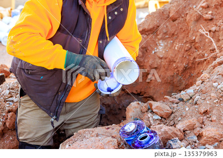 Workers are installing plumbing drainage pipes in various pipe layouts at trench construction area Workers are installing plumbing drainage pipes in various pipe layouts at trench construction area 135379963