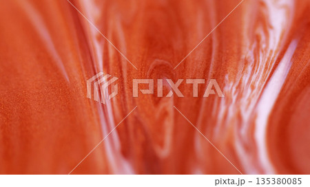 Ink splash. Glitter mix. Defocused orange bronze pigment in water grain texture marble fluid floating on abstract art wet background. 135380085