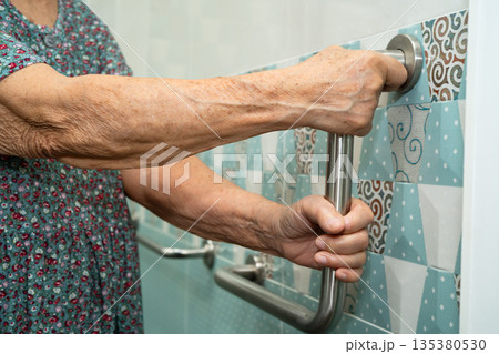 Asian elderly woman patient use toilet bathroom handle security in nursing hospital, healthy strong medical. Asian elderly woman patient use toilet bathroom handle security in nursing hospital, healthy strong medical. 135380530