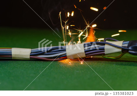 Sparks and smoke appear in electrical wiring during a critical malfunction. Sparks and smoke appear in electrical wiring during a critical malfunction. 135381023
