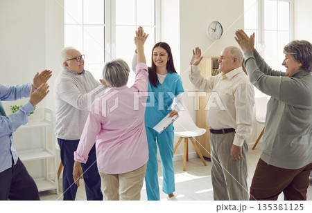 Group of happy senior people together with young nurse having fun at retirement home Group of happy senior people together with young nurse having fun at retirement home 135381125