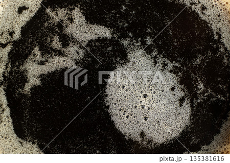 Macro texture of golden coffee foam with many small bubbles. 135381616