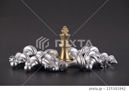 Victorious golden king with group of lying silver chess pieces Victorious golden king with group of lying silver chess pieces 135381942