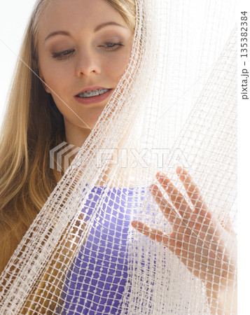 Woman relaxing on windowsill Woman relaxing on windowsill 135382384