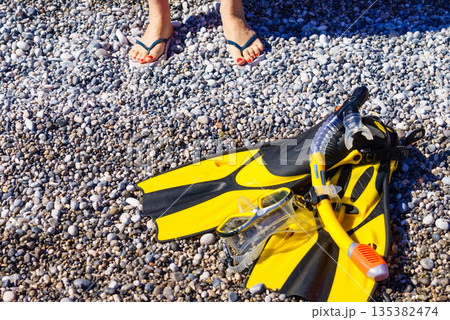 Woman with flippers snorkeling tube on beach 135382474