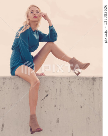 Fashion model wearing blue jumpsuit Fashion model wearing blue jumpsuit 135382626