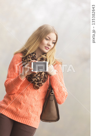 Happy fashion woman in park taking selfie photo. Happy fashion woman in park taking selfie photo. 135382643