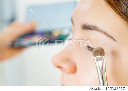 Makeup artist applying eye make up Makeup artist applying eye make up 135382657