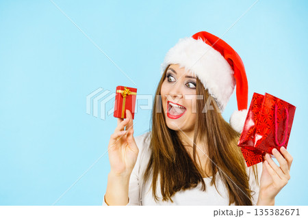 Happy Christmas woman holds red gift box Happy Christmas woman holds red gift box 135382671