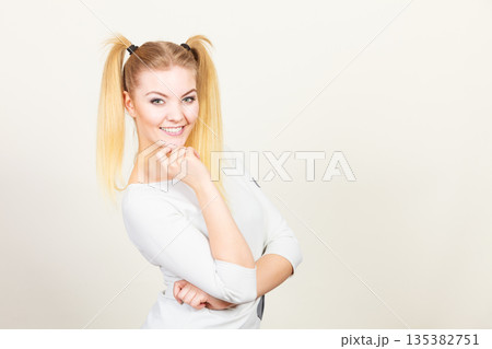 Happy blonde teenager girl with ponytails 135382751