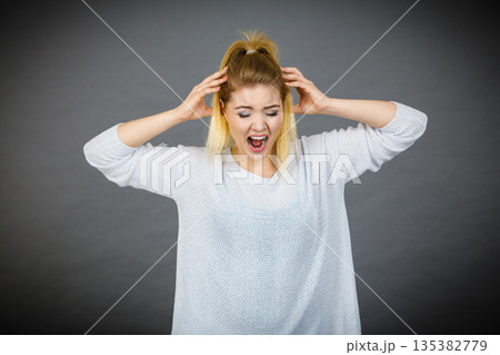 Unhappy woman screaming and yelling in pain Unhappy woman screaming and yelling in pain 135382779