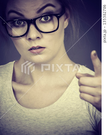 Woman wearing eyeglasses pointing at camera Woman wearing eyeglasses pointing at camera 135382786