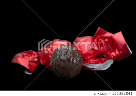 chocolate candies in red wrappers 135382841