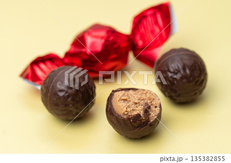 chocolate candies in red wrappers 135382855