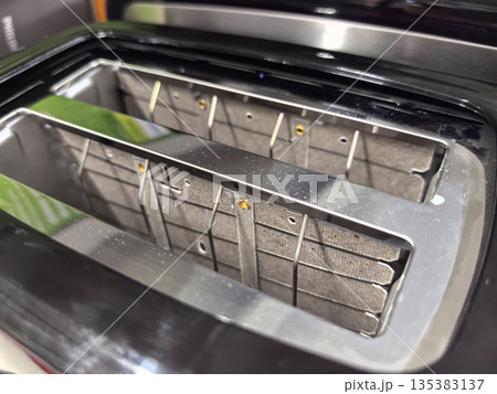 Shiny toaster with empty slots ready for breakfast toast preparation Shiny toaster with empty slots ready for breakfast toast preparation 135383137