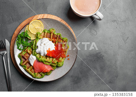 Healthy low carb breakfast with green avocado waffles, salmon, red caviar, soft cheese 135383158