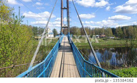 A bridge over a river with a blue railing 135384162