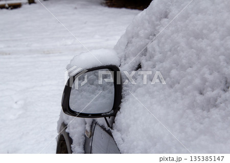 Mirror of a four-wheel drive car covered with snow 135385147