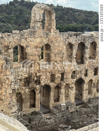Ancient Odeon of Herodes Atticus Amphitheater Ruins With Tiered Stone Seats And Arched Walls, Athens Greece 135385889