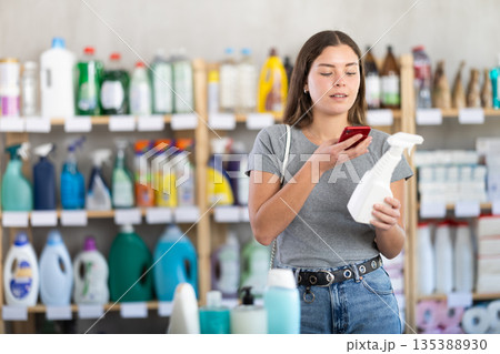 Woman scanning package with spray 135388930