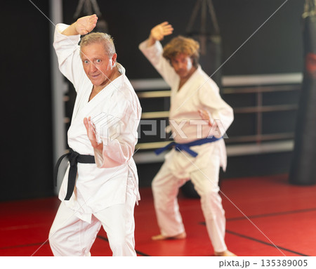 Man with other athletes of different ages during karate classes Man with other athletes of different ages during karate classes 135389005