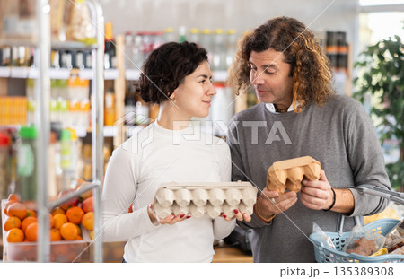 Couple picking eggs 135389308