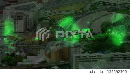Highlighting aerial highway interchange weaving through dense city blocks, with green code overlays 135392566