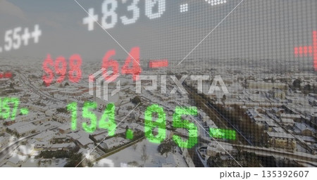 Overlaying green and red stock ticker numbers over snow-covered suburban rooftops and bare trees Overlaying green and red stock ticker numbers over snow-covered suburban rooftops and bare trees 135392607