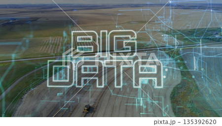 Displaying stylized BIG DATA text overlaying farmland, with tractor and circuit patterns 135392620