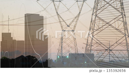 Three steel lattice power towers standing at power substation at dusk, with overhead power lines Three steel lattice power towers standing at power substation at dusk, with overhead power lines 135392656