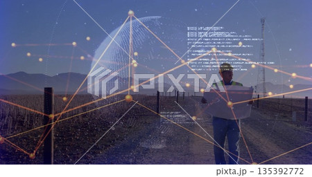 Scanning field technician analyzing data on tablet at site at dawn, digital overlay, copy space Scanning field technician analyzing data on tablet at site at dawn, digital overlay, copy space 135392772