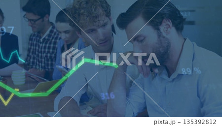 Two male analysts in blazers reviewing reports in conference room, examining paper charts Two male analysts in blazers reviewing reports in conference room, examining paper charts 135392812